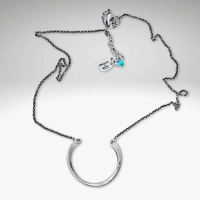 Horseshoe Necklace with a lightly hammered semi-circle pendant on a delicate rolo chain.