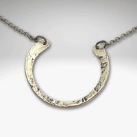 Horseshoe Necklace with a lightly hammered finish on a delicate rolo chain, perfect for everyday wear.