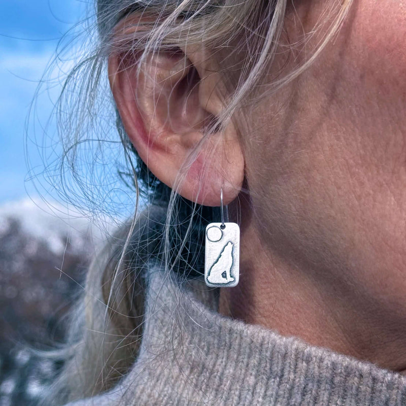 Howl Earrings featuring a howling wolf design against a full moon on a classic earwire.