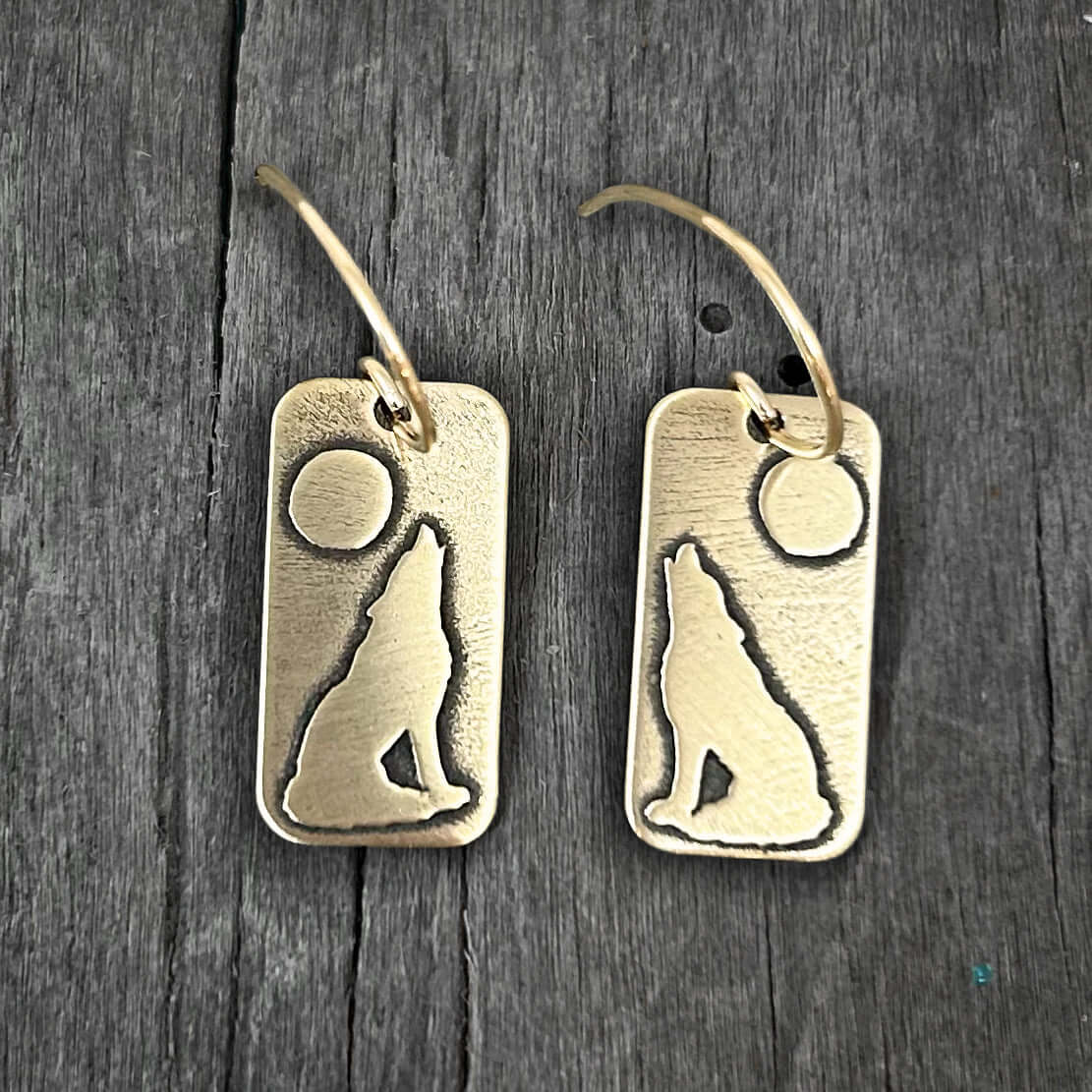 Howl Earrings featuring a howling wolf and full moon design, crafted in raw brass with earwire.