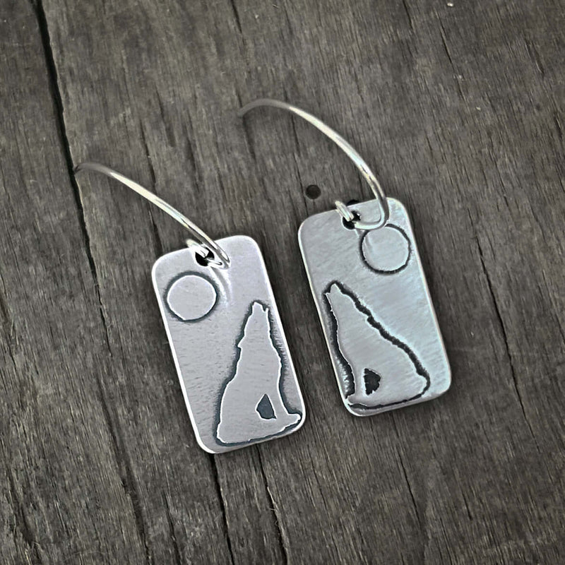Howl Earrings featuring a howling wolf design against a full moon with sterling silver earwires.