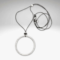 Hula Necklace featuring a large raw brass circle on a soft monofilament cord with adjustable lengths.