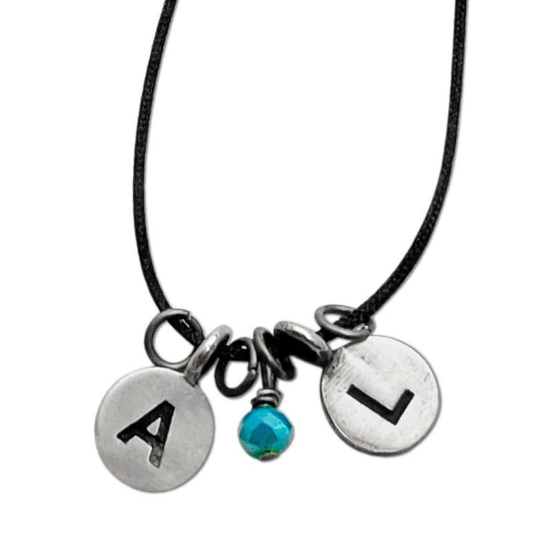Initial Necklace with engraved letters A and L, featuring a turquoise bead on a simple black cord.