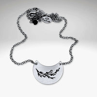 Juniper Necklace on a silver chain featuring a pendant with Juniper leaves and berries design.