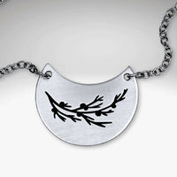 Juniper Necklace featuring a silver pendant with a Juniper sprig design on a rolo chain.
