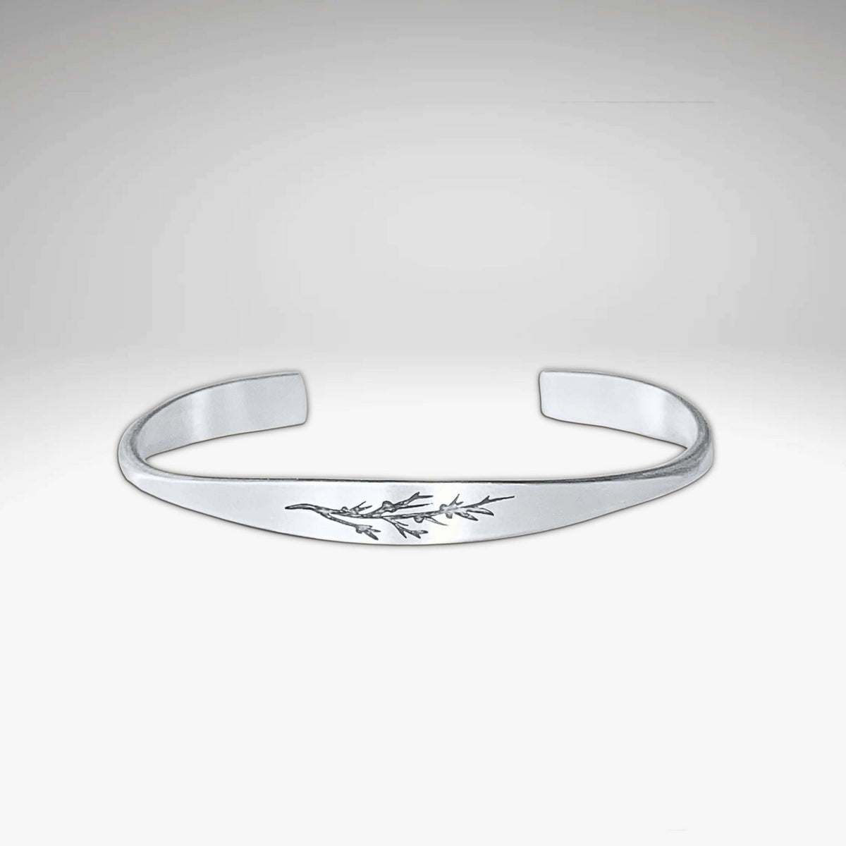 Juniper Signet Cuff Bracelet in matte silver finish with etched juniper twig design.