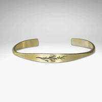 Juniper Signet Cuff Bracelet featuring an etched juniper twig design in solid brass.