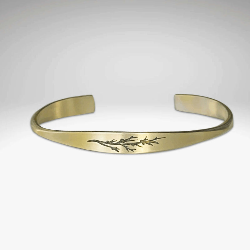 Juniper Signet Cuff Bracelet featuring an etched juniper twig design in solid brass.