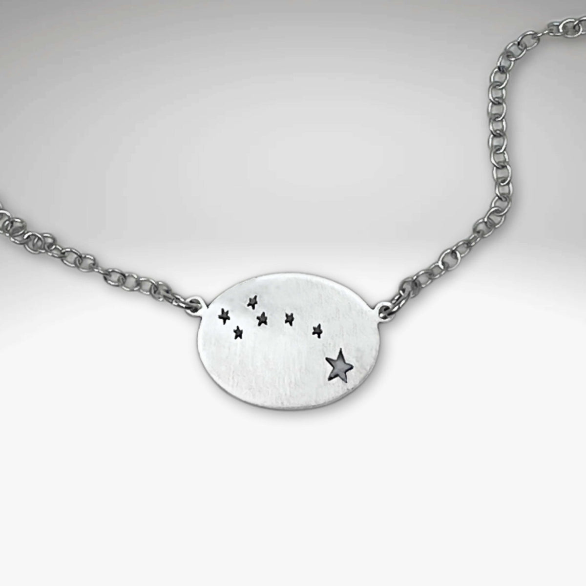 Little Dipper Necklace featuring seven stars of Ursa Minor in a chic matte silver finish.