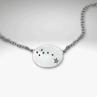 Little Dipper Necklace featuring seven stars of Ursa Minor in a chic matte silver finish.
