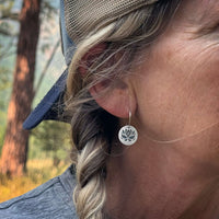 Close-up of a woman wearing Lotus Flower Earrings in matte silver, showcasing elegance and nature-inspired design.