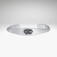 Lotus Signet Cuff Bracelet featuring a sleek silver design with a lotus motif.