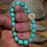 Lotus Stretch Bracelet - Gemstone Beaded Stretchy Bracelet featuring turquoise beads and a lotus charm.