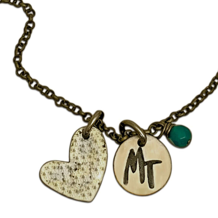 Love Montana Necklace featuring a heart charm and engraved MT disc on a chain.