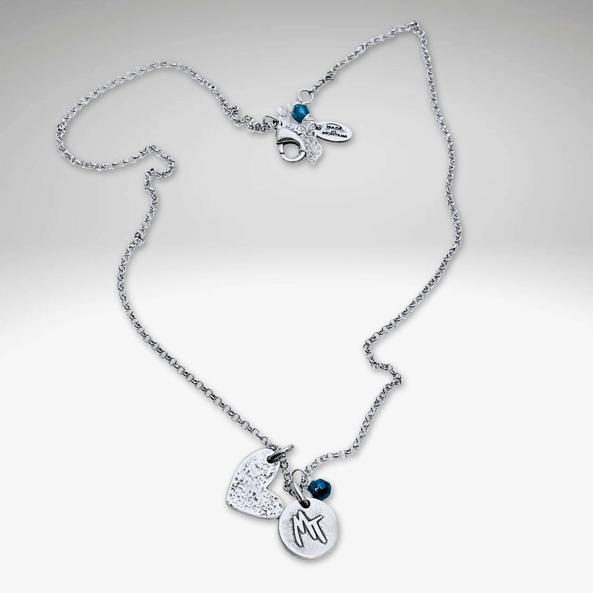 Love Montana Necklace featuring a light hammer finish with delicate MT engraving and blue accents, available in Matte Silver.