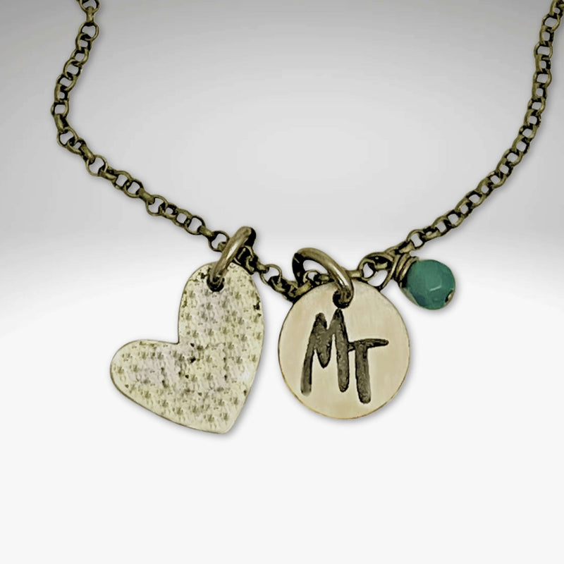 Love Montana Necklace featuring a heart charm and an engraved MT disc on a delicate chain.