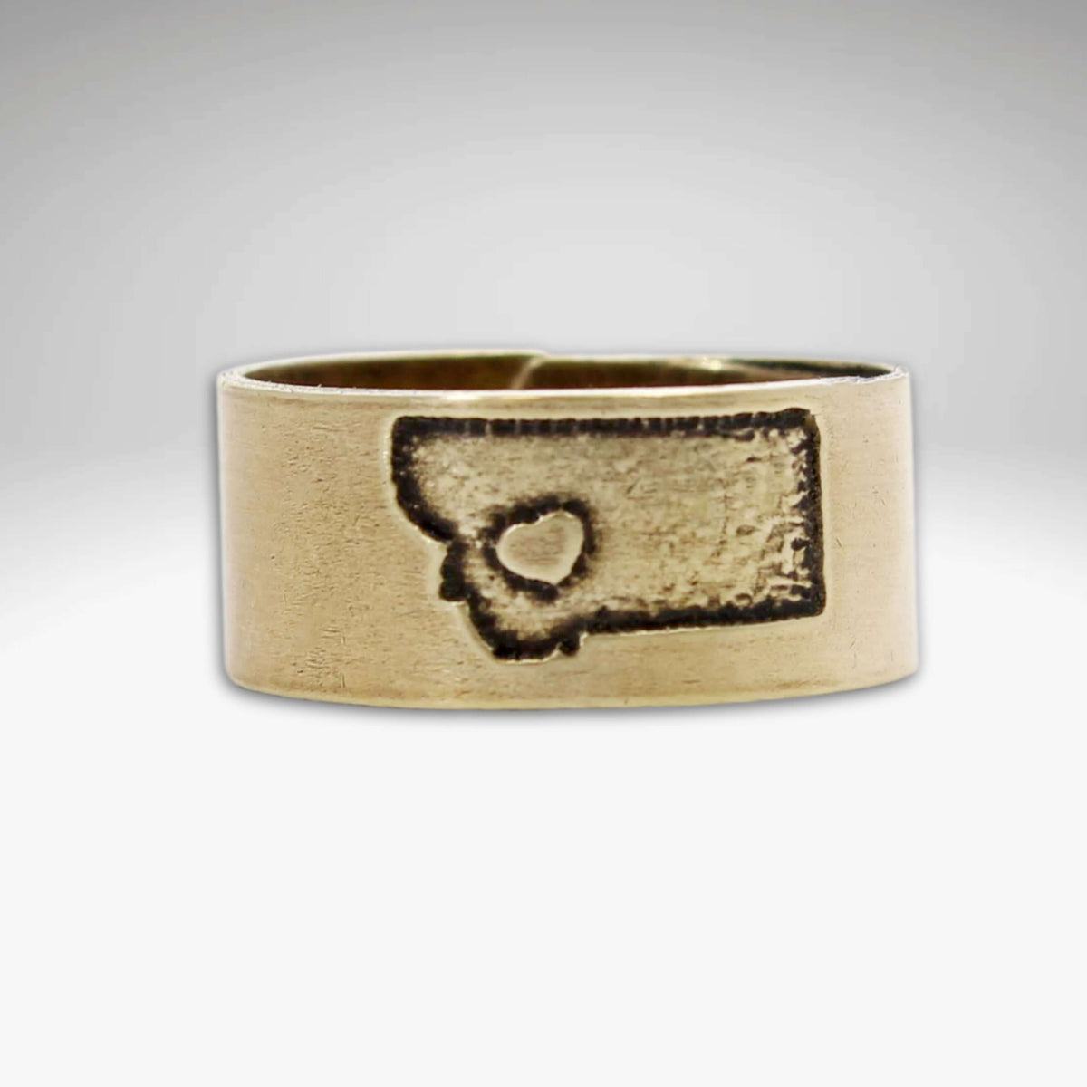 Lovin' Montana Ring featuring an etched outline of Montana and a heart, available in Matte Silver and Antique Brass finishes.