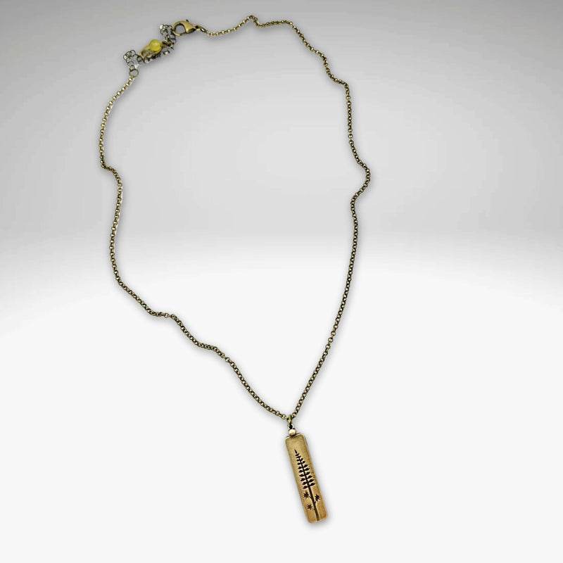 Lupine Necklace featuring a delicate gold pendant on an adjustable rolo chain, perfect for summer accessories.