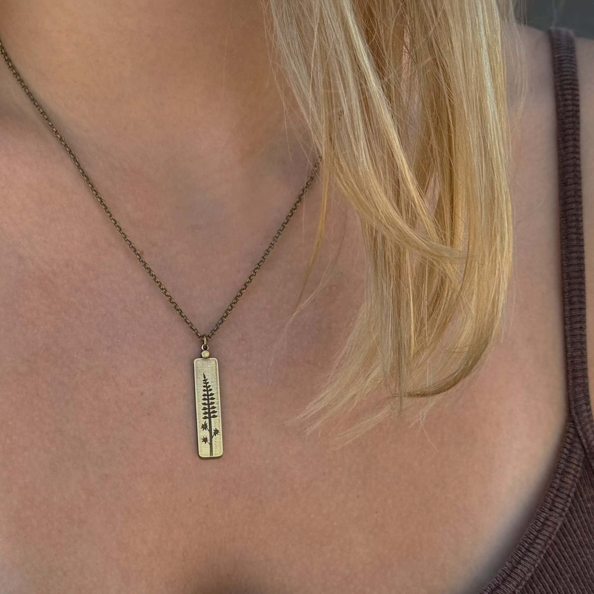 Lupine Necklace featuring a botanical design, worn on a model's neck, showcasing summertime beauty and elegance.