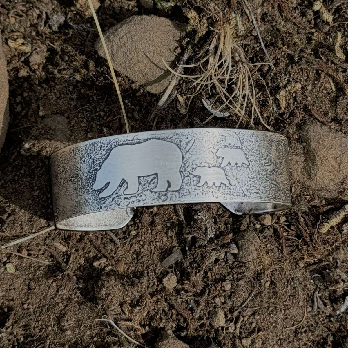 Mama and Cubs Cuff Bracelet featuring bears etched on a textured raw brass surface.