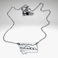 Mama and Cubs Necklace showcasing a mother grizzly bear and cubs, crafted in raw brass on an adjustable cable chain.