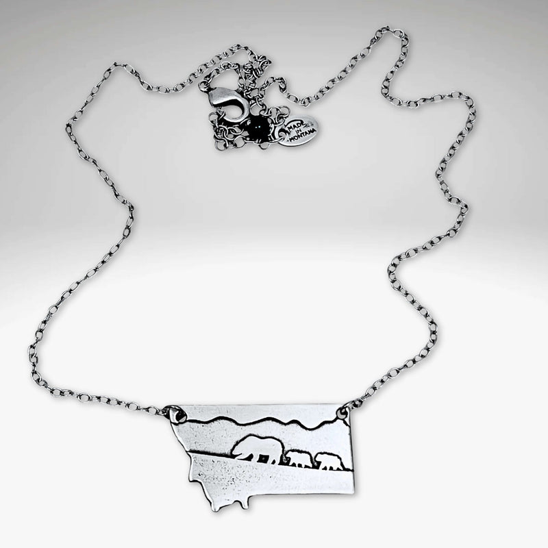 Mama and Cubs Necklace showcasing a mother grizzly bear and cubs, crafted in raw brass on an adjustable cable chain.