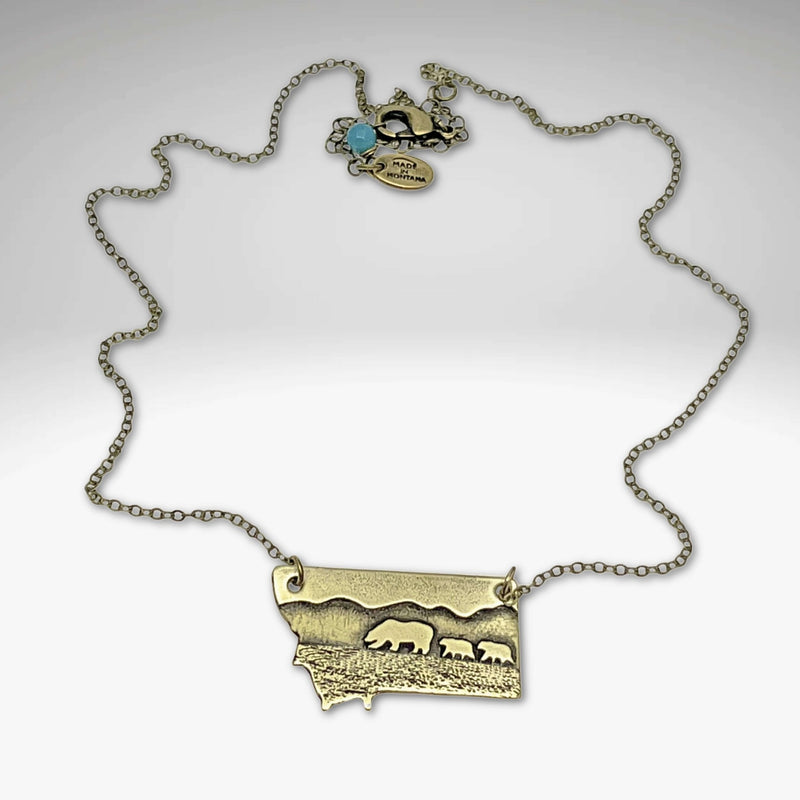 Mama and Cubs Necklace showcasing a mother bear and cubs, crafted in raw brass with adjustable chain.
