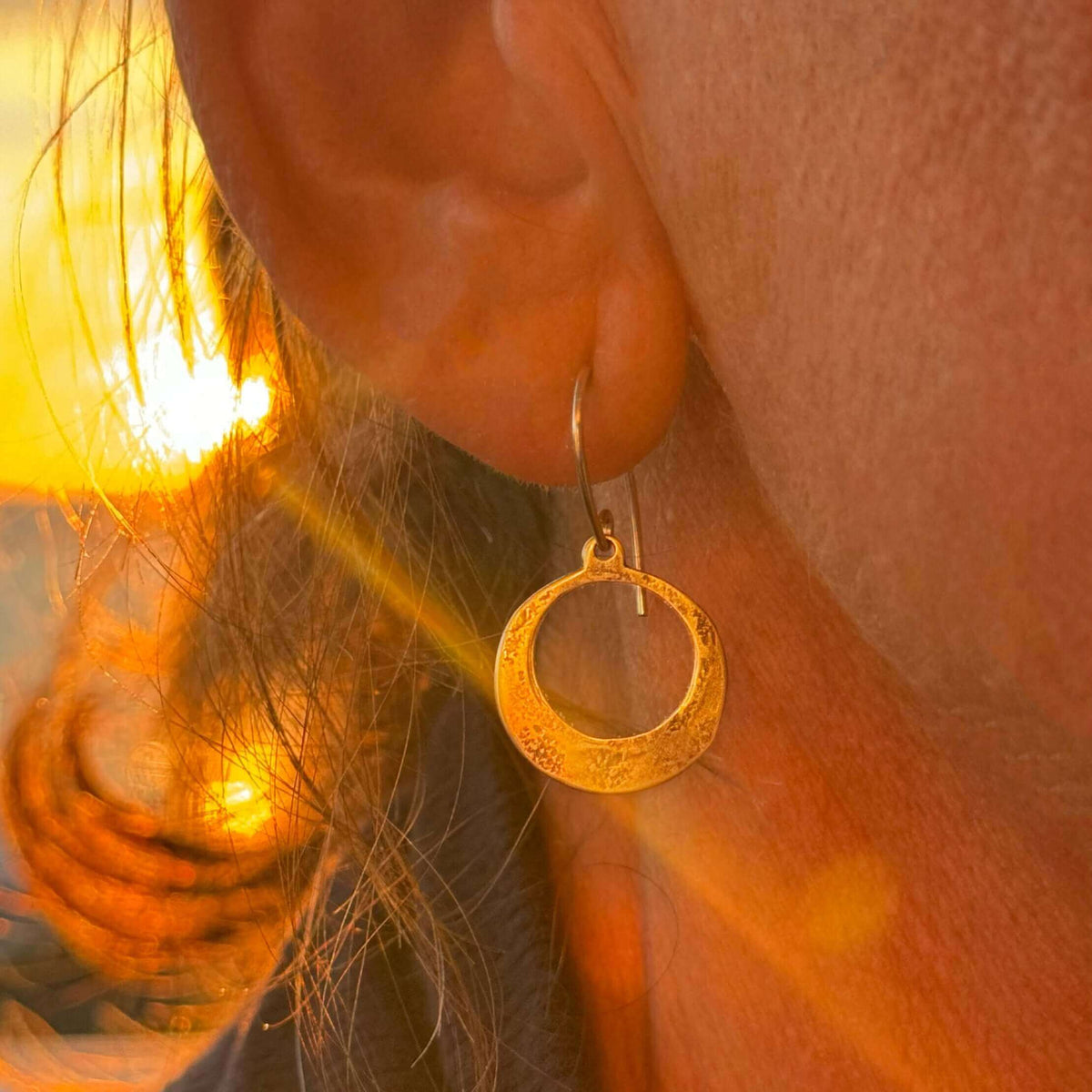Mini Discs Earrings showcasing unique hammered texture in warm sunlight, perfect for everyday elegance.
