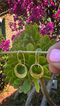 Mini Discs Earrings showcasing hand hammered antique brass design against vibrant foliage and flowers.
