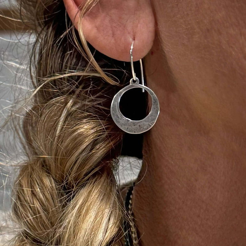 Mini Discs Earrings worn by a model showcasing the unique hammered texture and elegant design.