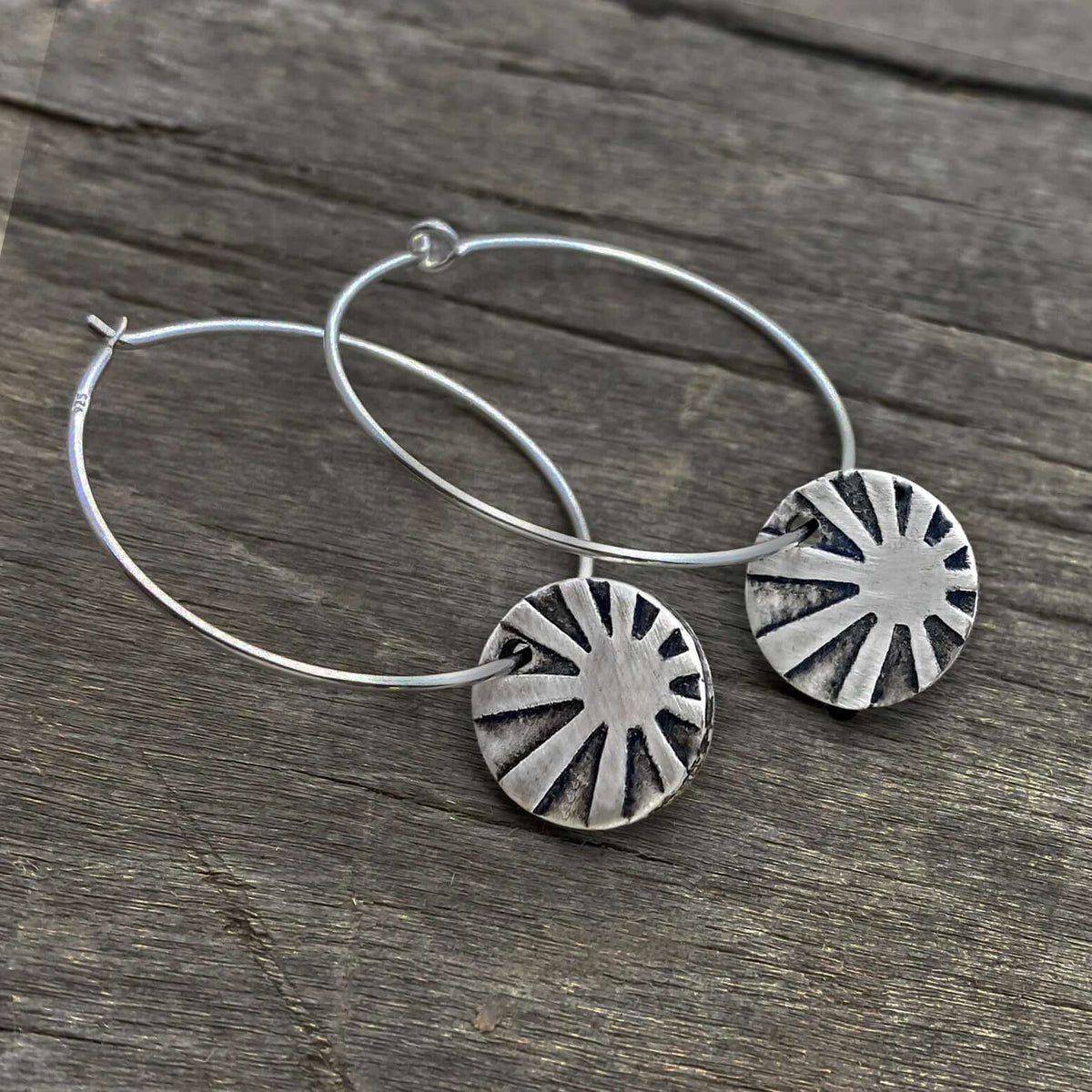 Mini Sun Ray  Hoop Earrings showcasing etched sun rays in matte silver finish on comfortable hoop earwires.