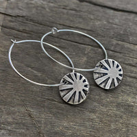 Mini Sun Ray  Hoop Earrings showcasing etched sun rays in matte silver finish on comfortable hoop earwires.