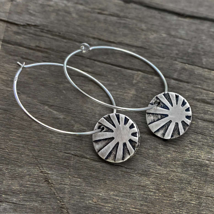 Mini Sun Ray  Hoop Earrings showcasing etched sun rays in matte silver finish on comfortable hoop earwires.