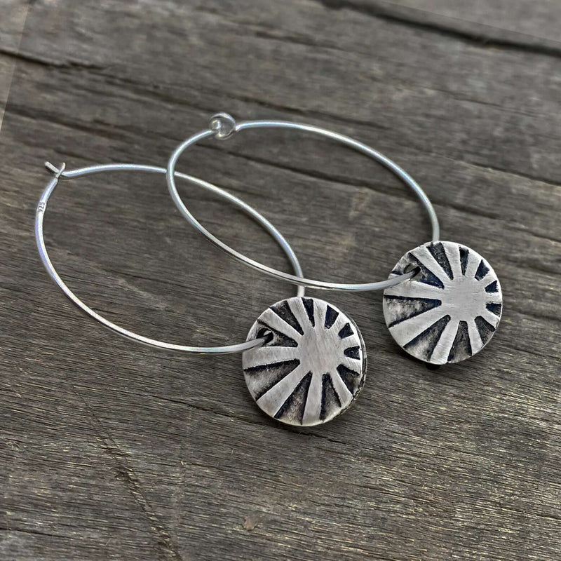 Mini Sun Ray  Hoop Earrings showcasing etched sun rays in matte silver finish on comfortable hoop earwires.