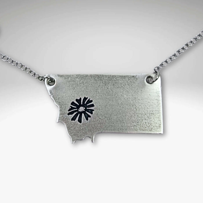 Montana Bitterroot Necklace featuring a Montana state silhouette and floral design in matte silver finish.