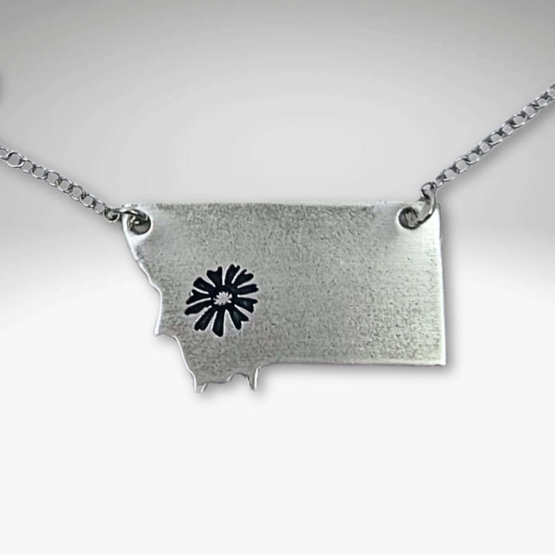 Montana Bitterroot Necklace featuring a Montana state silhouette and floral design in matte silver finish.