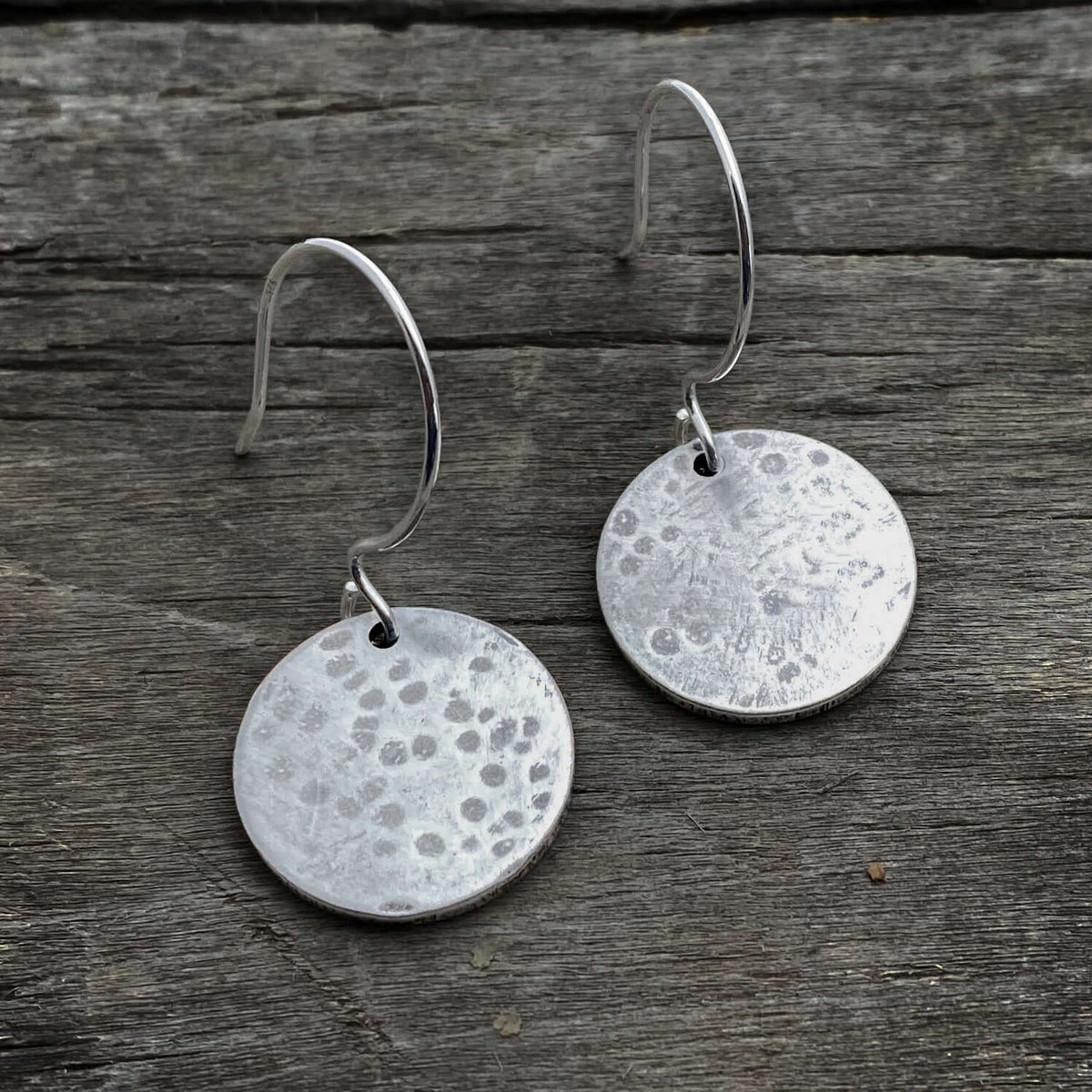 Moon Drops Earrings featuring hammered matte silver round disks on hooks, perfect for everyday wear.