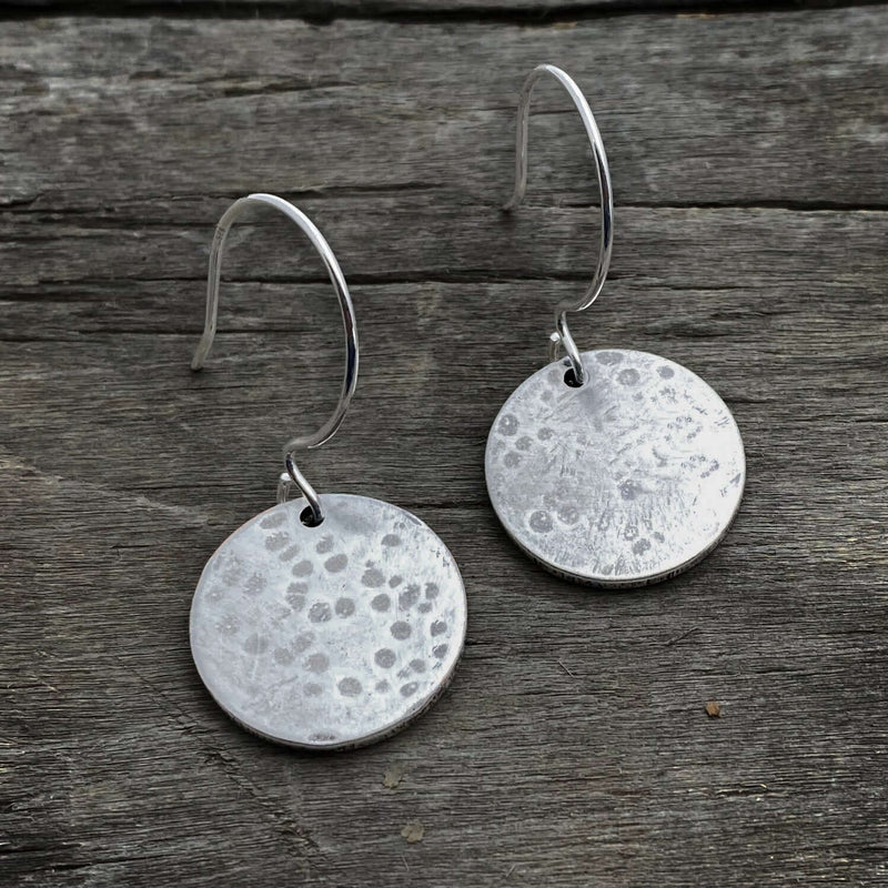 Moon Drops Earrings featuring hammered matte silver round disks on hooks, perfect for everyday wear.