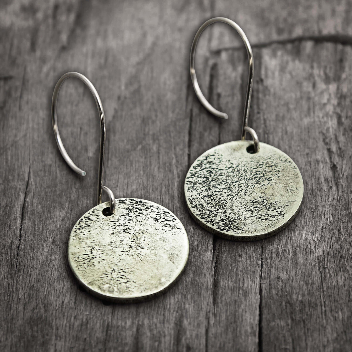 Moon Drops Earrings in matte silver with textured round disks, ideal for everyday wear.