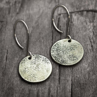 Moon Drops Earrings in matte silver with textured round disks, ideal for everyday wear.
