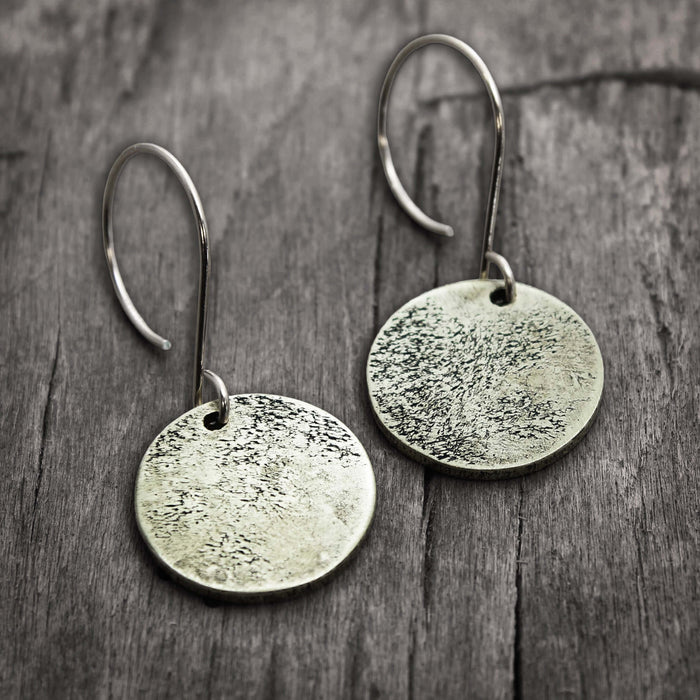 Moon Drops Earrings in matte silver with textured round disks, ideal for everyday wear.