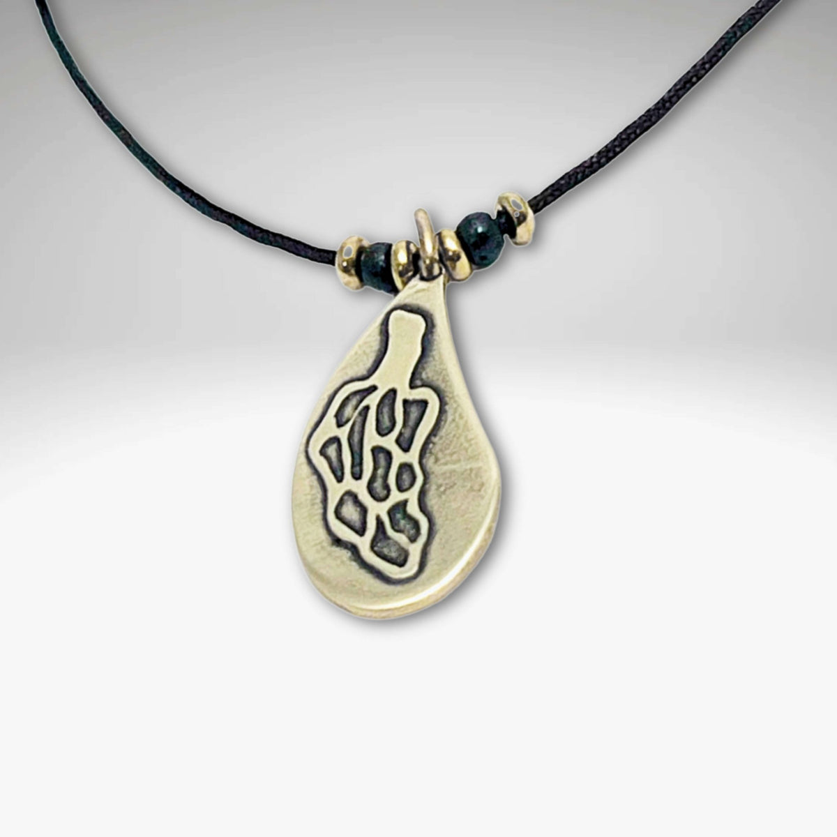 Morel Mushroom Necklace featuring a solid brass pendant on a leather cord with decorative beads.