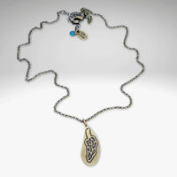 Morel Mushroom Necklace featuring intricate brass etching and a stylish rolo chain design.