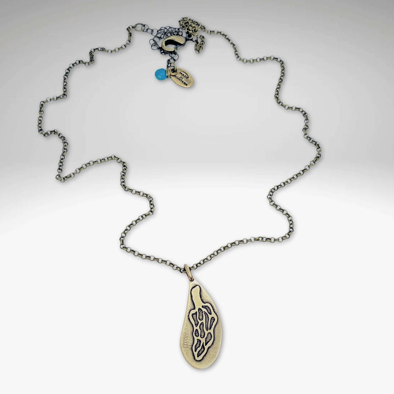 Morel Mushroom Necklace featuring intricate brass etching and a stylish rolo chain design.