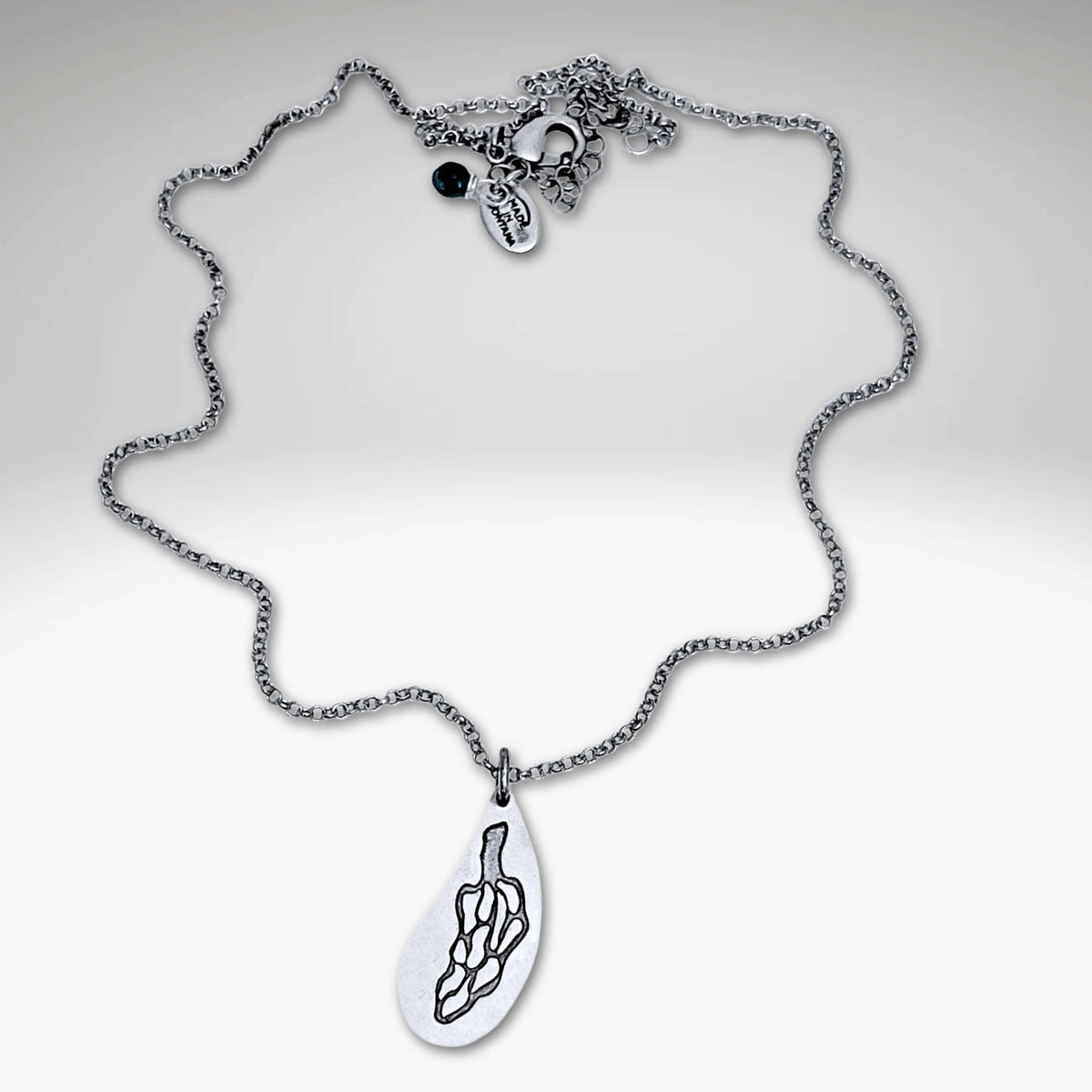 Morel Mushroom Necklace featuring an intricately etched morel pendant on a delicate chain.