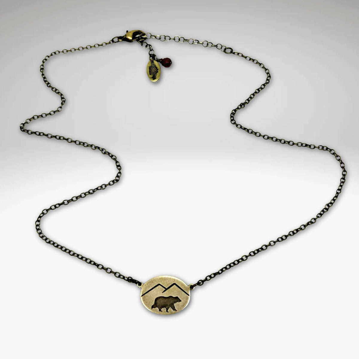 Mountain Bear Necklace in antique brass finish with a bear pendant and adjustable chain, made in Montana.
