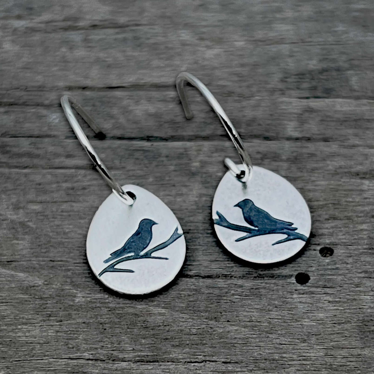 Mountain Bluebird Earrings featuring etched bluebirds on teardrop shapes in sterling silver finish.