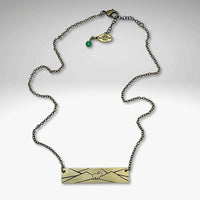 Mountain Goat Necklace on an antique brass chain with a mountain design, perfect for nature enthusiasts.