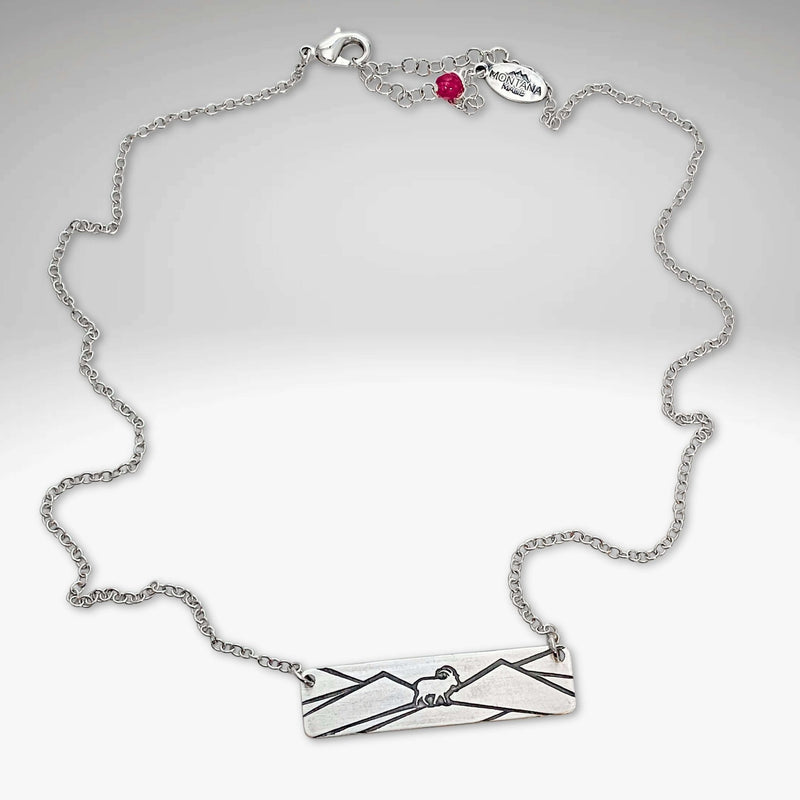 Mountain Goat Necklace on an adjustable silver chain, featuring mountain and goat design, perfect for nature enthusiasts.