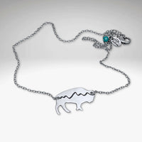 Mountains on Buffalo Necklace featuring a bison design on a silver chain.